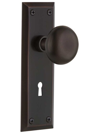 New York Mortise Lock Set With Round Brass Knobs in Timeless Bronze.